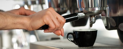 Portafilter being attached to the machine