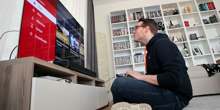 No, you don't need to sit that close to the TV