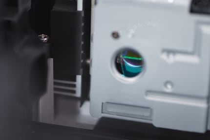 A narrow beam of light shines through this small hole. On the other side it hits the colour wheel. Only one colour is hit at a time.