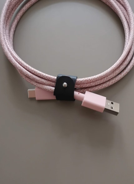 The leather strap is used to wrap the nylon-sheathed cable.