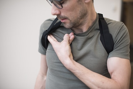 Not too tight: you should be able to fit two fingers underneath the straps.