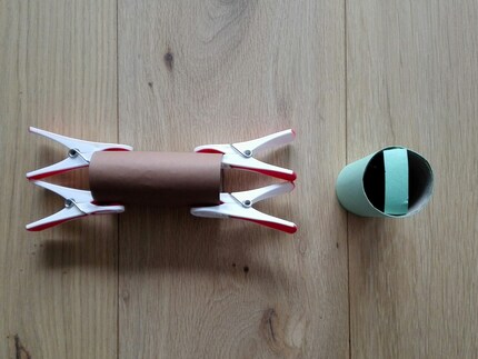 Bild 2: Klebe das Papier und den Streifen an die WC-Rolle.