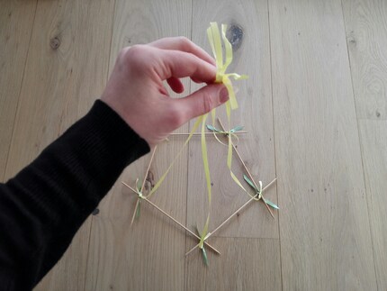 Bild 6: Knote alle fünf Bänder am oberen Ende zusammen.