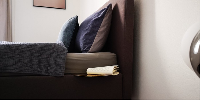 All it needs to attach it and is a slot in the frame of the bed or sofa.