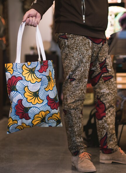 His favourite things to wear are wax print trousers.