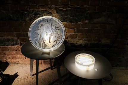 There are two versions of the lamp: one is a wall-hung, round lamp and the other is a table lamp that’s reminiscent of laboratory glassware.
