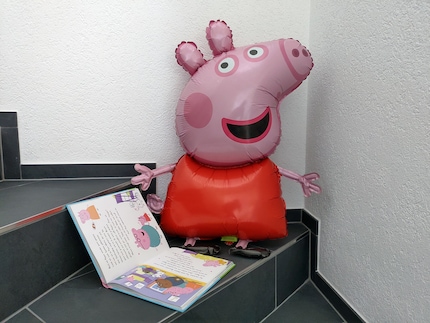 The pink piggy lights up children's eyes in many different ways.