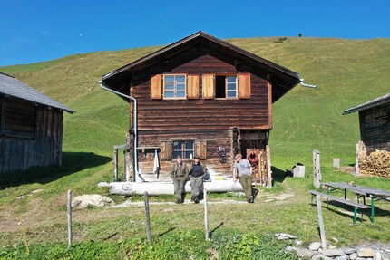 The «men of the house» in front of their hut: Marco, Claudio and Marc.