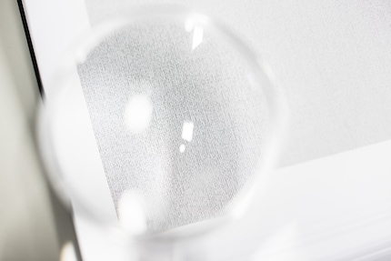 The letters that make up people: only visible through a magnifying glass and even then barely.