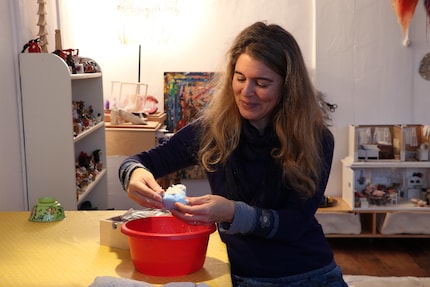 Brigit mixes the modelling clay. The red colour of the tub is no coincidence.