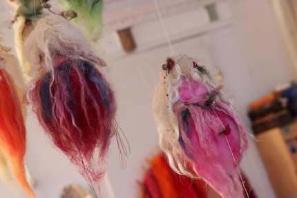 A mobile made of magical figures adorns the ceiling of the figure studio.