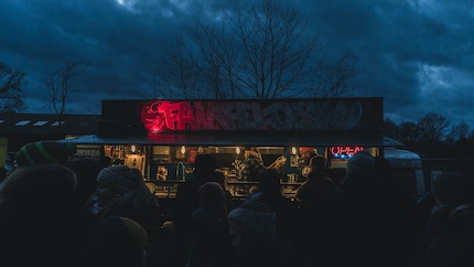 These people will soon have money taken out of their pockets. A food truck somewhere in Germany. 