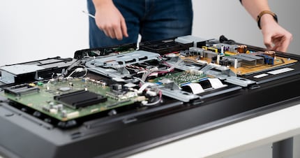 Four circuit boards: the orange one is the power supply. The large green circuit board is home to two TV processors.