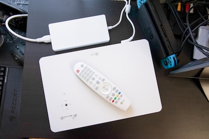 The projector's power supply is quite flat, but quite large. A remote control is also included with the device