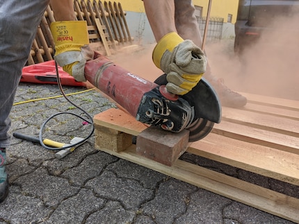 The angle grinder makes short work of the stones.