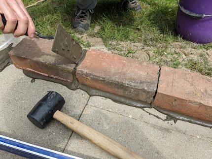 Apply mortar for one or two bricks at a time.