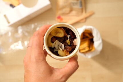 You can transport your food in the original packaging, but it's best to get rid of it when setting up.