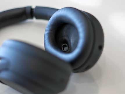 The small sensor is located in the reflective rectangle in the earphones.