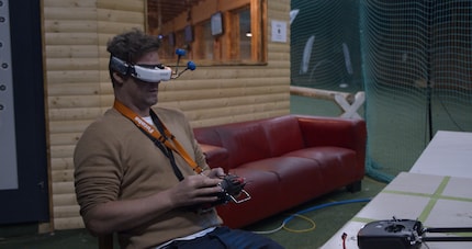 Mike's nimble fingers send the drone flying through the hall at breakneck speed.