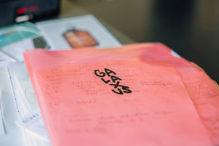 Loose pages containing ideas and sketches are bundled up in a folder.