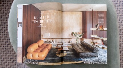 In this winning apartment, the shelf acts as a room divider just to the right behind the sofa.