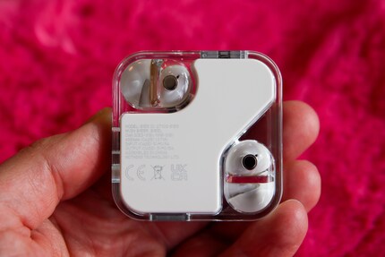 The white element protrudes slightly from the bottom of the case, like the bulges for the ear buds.