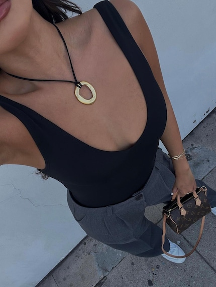 The charm on this Heaven Mayhem necklace is attached with an anchor stitch.