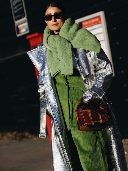 Influencer Julia Haghjoo wears a silver crocodile leather-look trench coat.