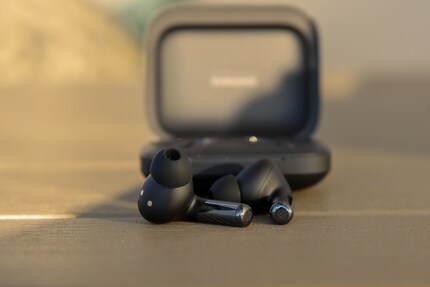 Microphones for phone calls are located at the bottom.