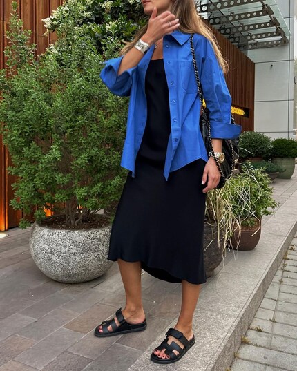 Even over an elegant slip dress, the button-down looks good.