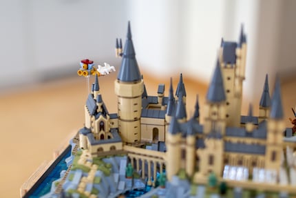 The Beauxbatons carriage soars over Hogwarts Castle.