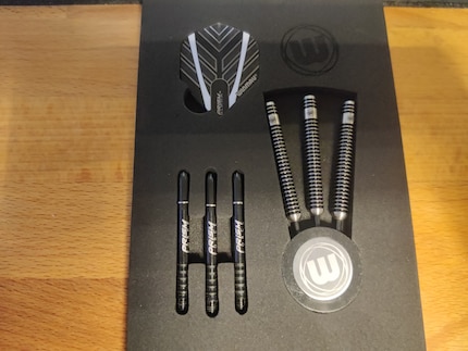 Barrels, black Prism Force shafts, Prism Alpha flights and a point protector come included with the Winmau darts. 