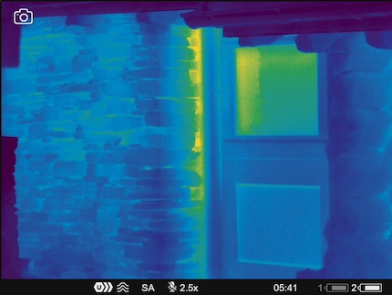 Heat escaping the door of an alpine hut.