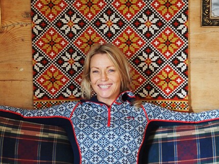 Skier and Olympic medallist Kari Traa sitting in front of the tapestry that started it all.