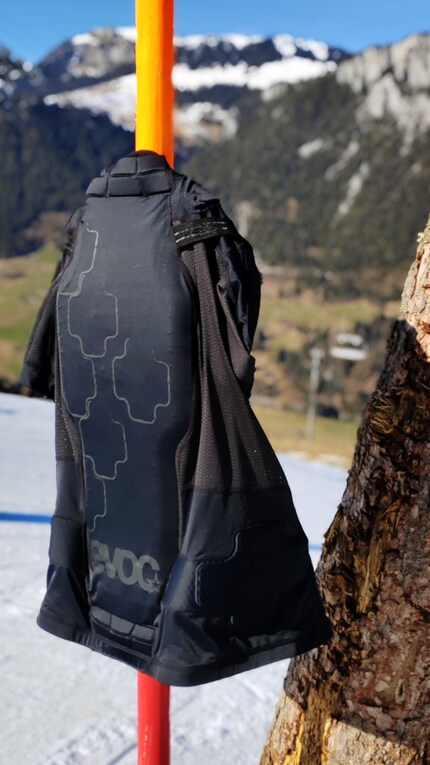The open protective jacket drying in the midday sun.