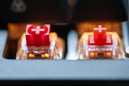Thanks to its design, the box-style switch (left) should wobble less than other MX-style switches (right).