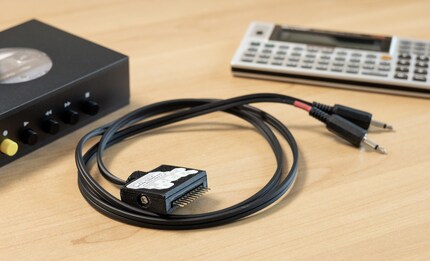 The cable connects the pocket computer to a tape recorder or a computer.