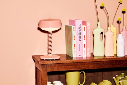 Bellboy shines with its semitransparent lamp stand, both on a chest of drawers and a garden table.