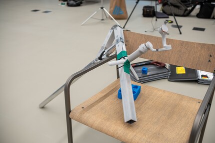 The «arm» will be mounted on the wheelchair. The gimbal at the top is attached in a makeshift manner with cable ties and adhesive tape.