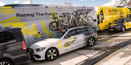 The sports director’s team car and the Q36.5 Pro Cycling Team bus at the finish line on the Gotthard Pass.