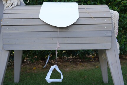 Creative, if a little flimsy: the first version of the saddle (cardboard) and stirrups (paper).