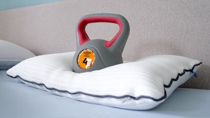 A head dummy demonstrating how much the pillow’s compressed under weight.