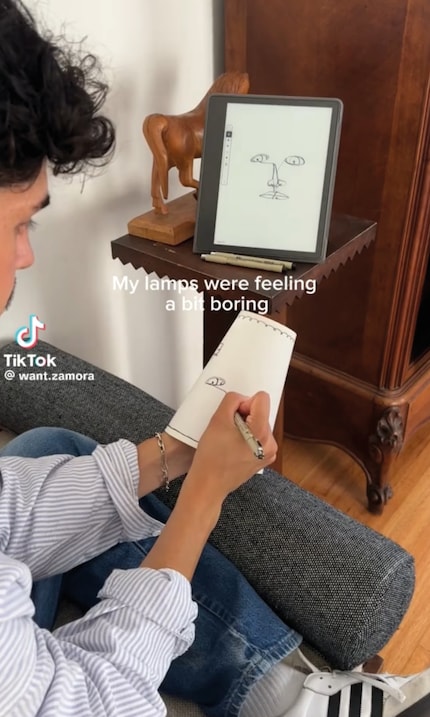 Marco Zamora uses a marker pen to draw on his lampshades.