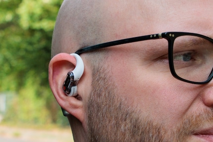 Headphones and glasses coexist peacefully.