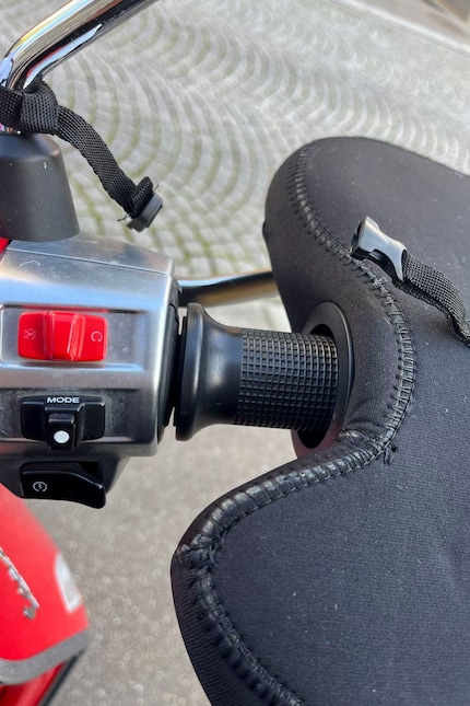 I simply slide the glove over the handlebar grip.