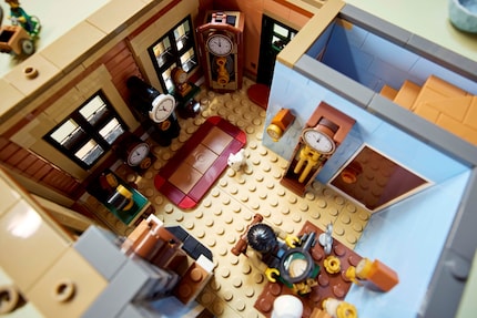 A watchmaker plying his trade on the second floor.