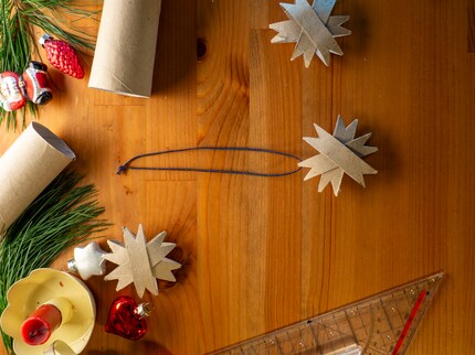 Use the string to hang the star on the Christmas tree.