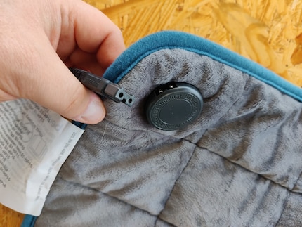 La prise d’alimentation du coussin chauffant se trouve dans l’une des alvéoles extérieures.
