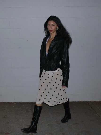 Feminine polka dot skirt with a robust leather jacket - a nice break in style.
