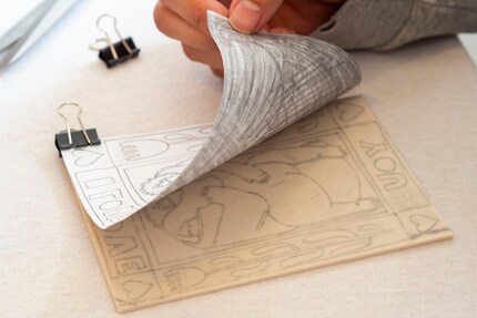 I use foldback clips to fix the sheet to the linoleum plate so that it doesn’t slip when I transfer it.